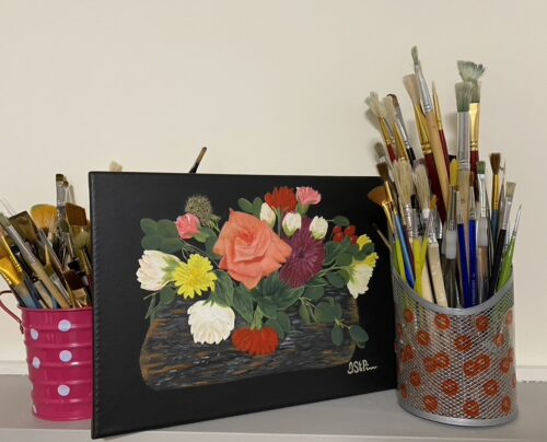 Painting of colorful flower arrangement with a small log base