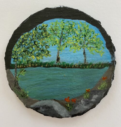 Coaster painted with an image of a pond and trees