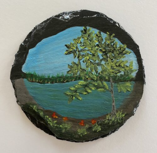 Coaster painted with an image of a pond and trees