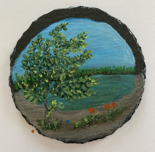 Coaster painted with an image of a pond and trees