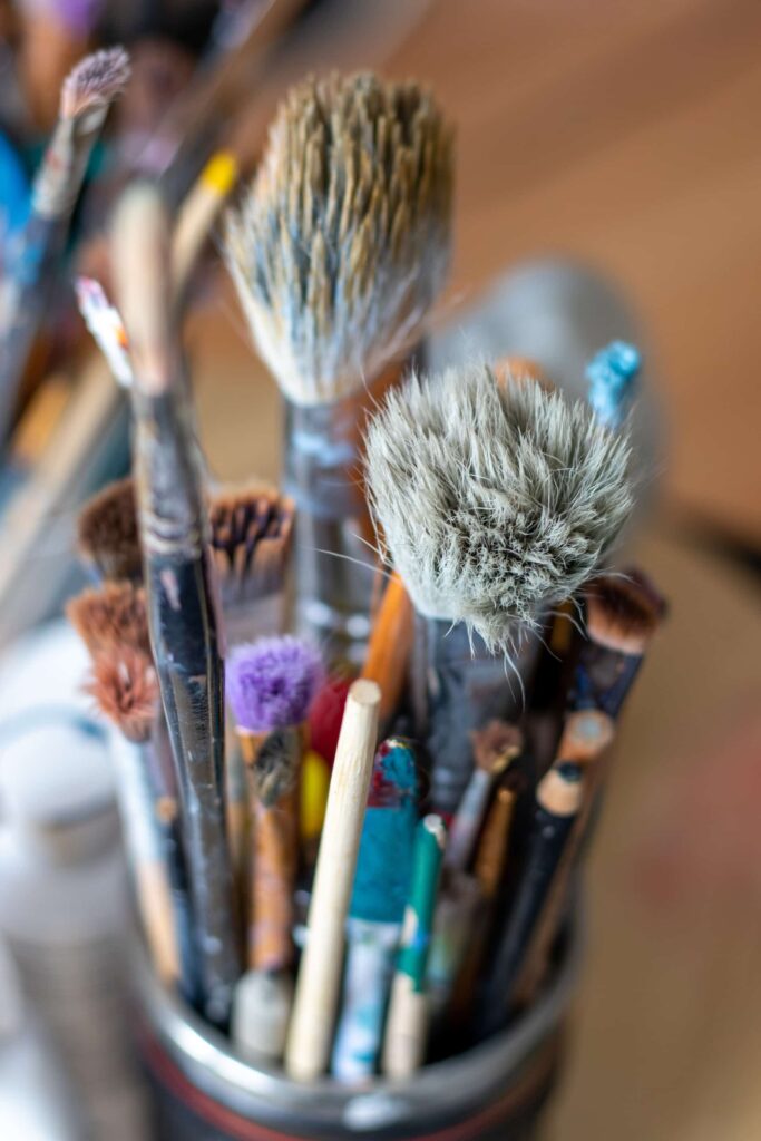 Jar of various sized artist paintbrushes