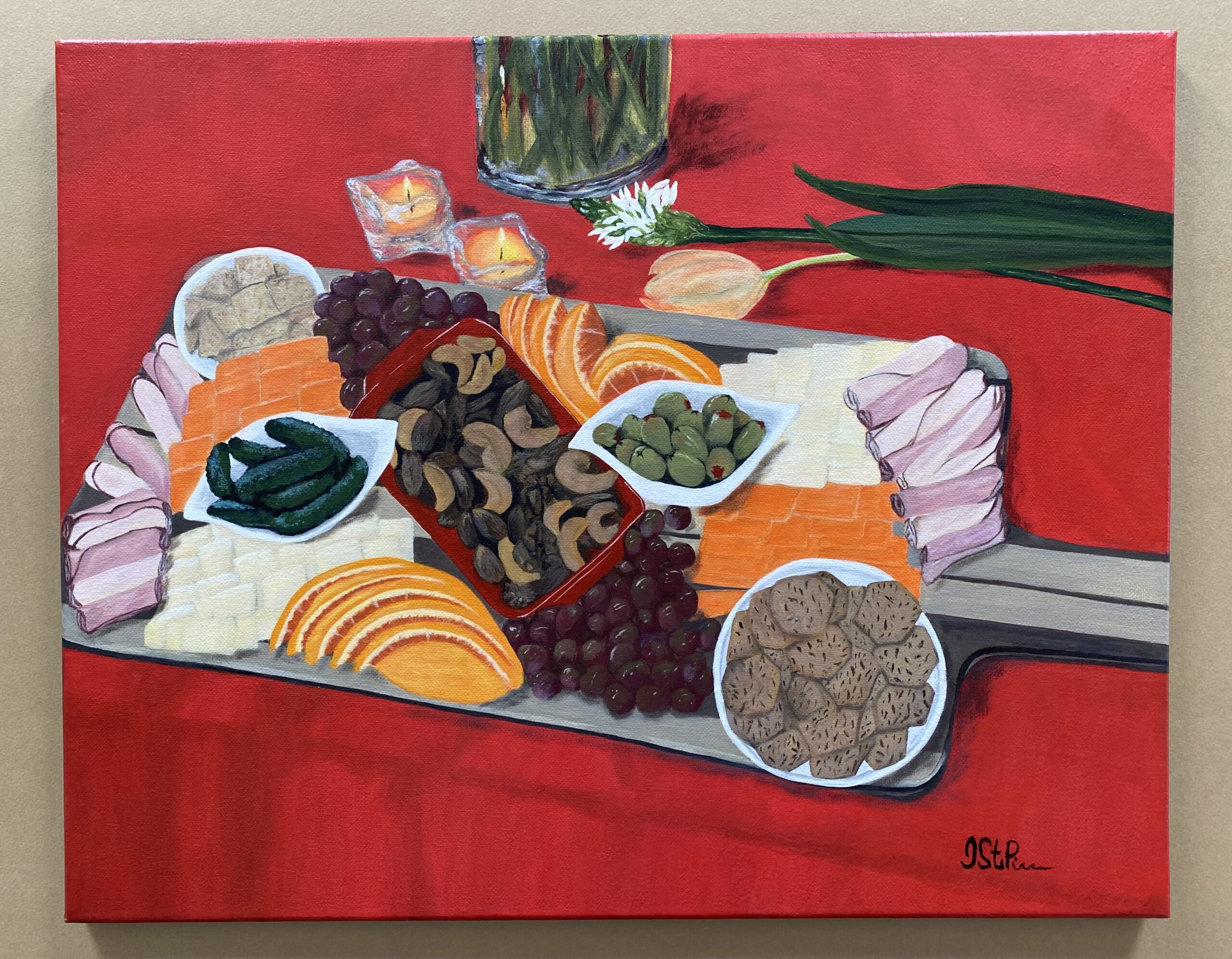 Large charcuterie board with foods on a red table cloth