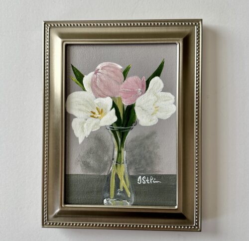 A small painting of pink and white tulips in a clear carafe