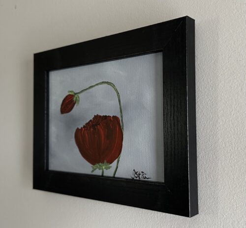 A painting of red poppies on a grey background in a black frame