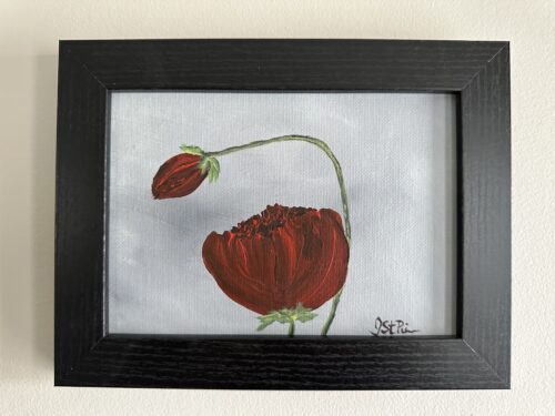 A painting of red poppies on a grey background in a black frame