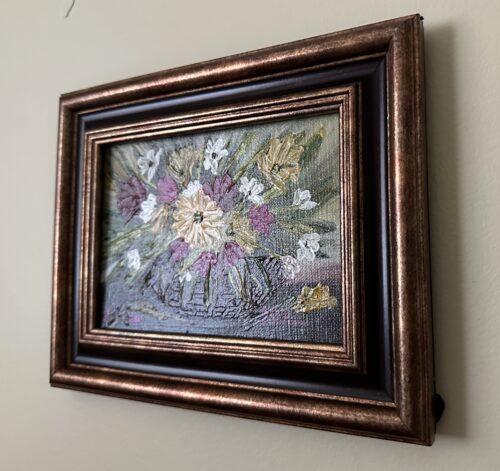 A palette knife painting of pink and yellow flowers in a basket