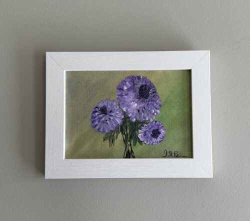 A painting of purple Chrysanthemums on a green background and in a white frame